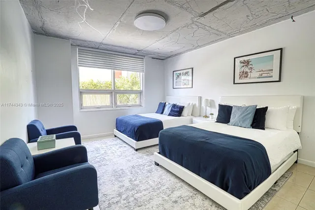 a bedroom with bed couch and window