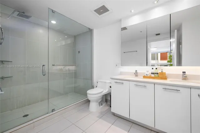 a bathroom with a toilet sink and shower