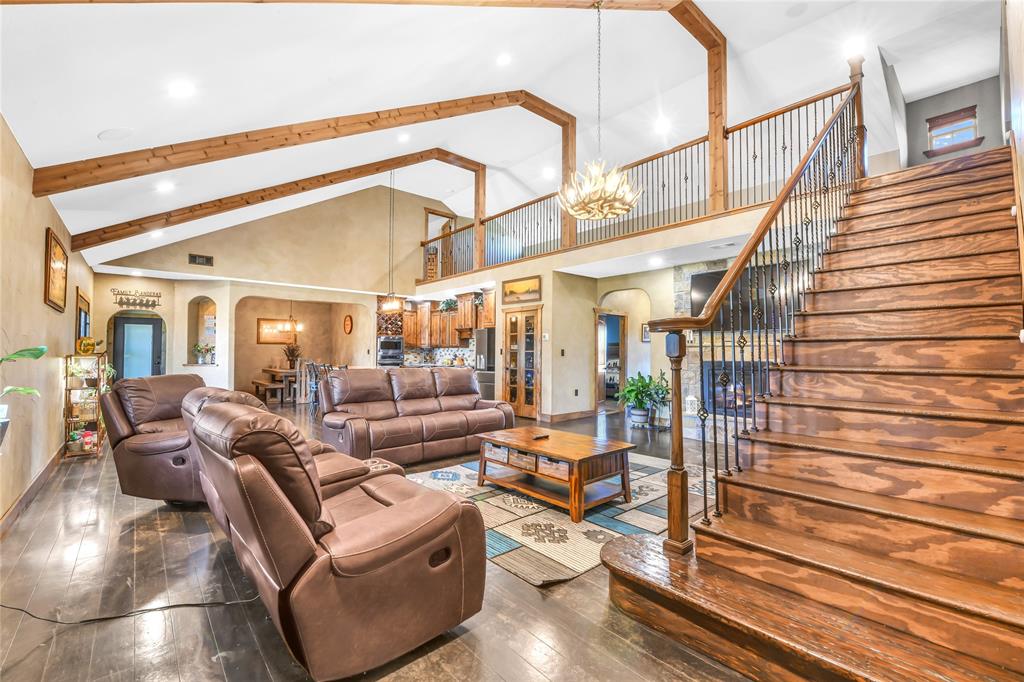 854 County Road 3330 Bridgeport, TX 76426 - Photo 24 of 40 Wood stairs with iron balusters lead the way to the 2nd floor with 2 more spacious bedrooms, a tv area all connected by a loft with windows and built in window seats.