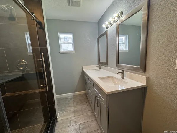 a bathroom with a sink toilet and shower