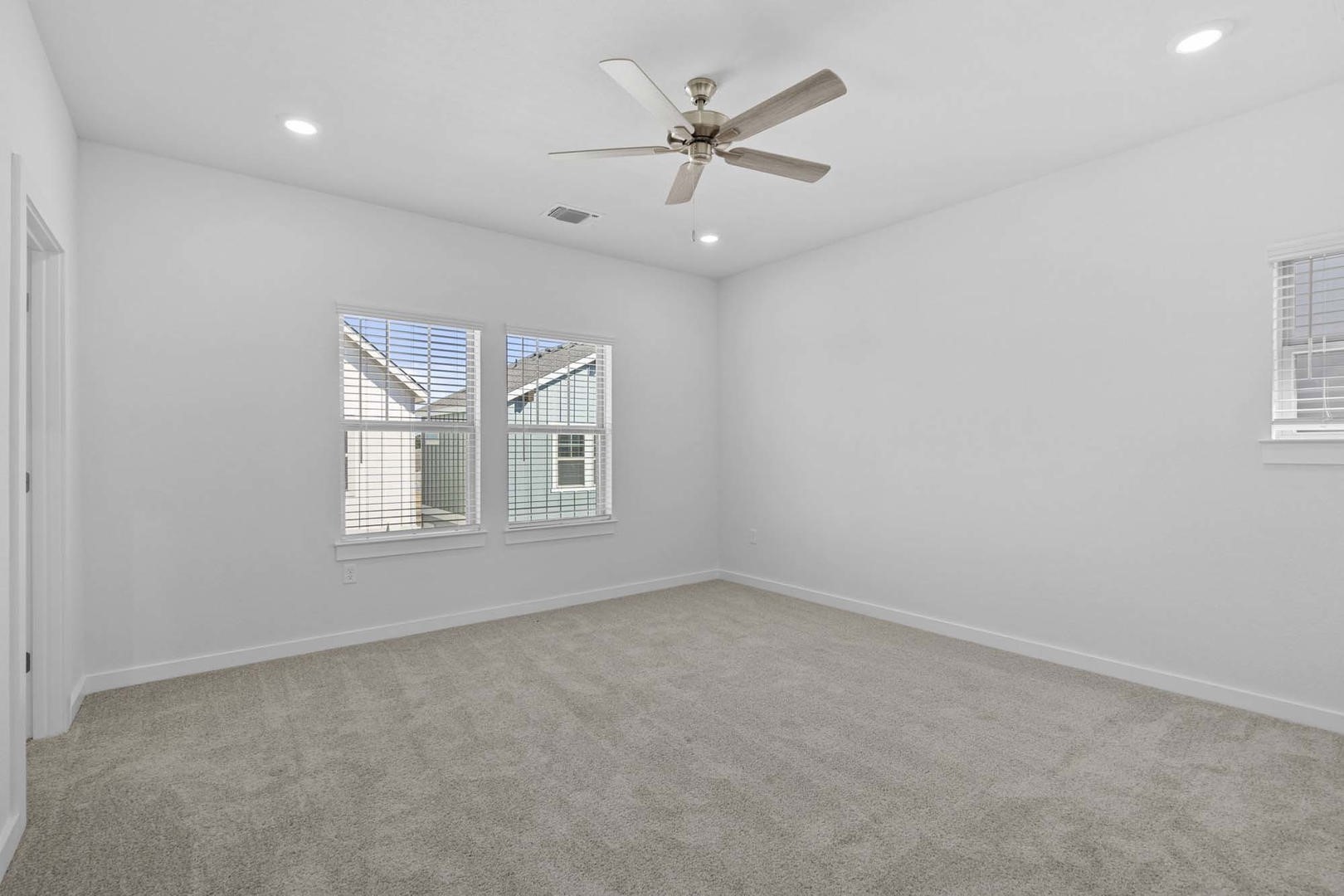 6400 Stockman Drive, Unit 6 Austin, TX 78747 - Photo 12 of 36 an empty room with chandelier fan and windows
