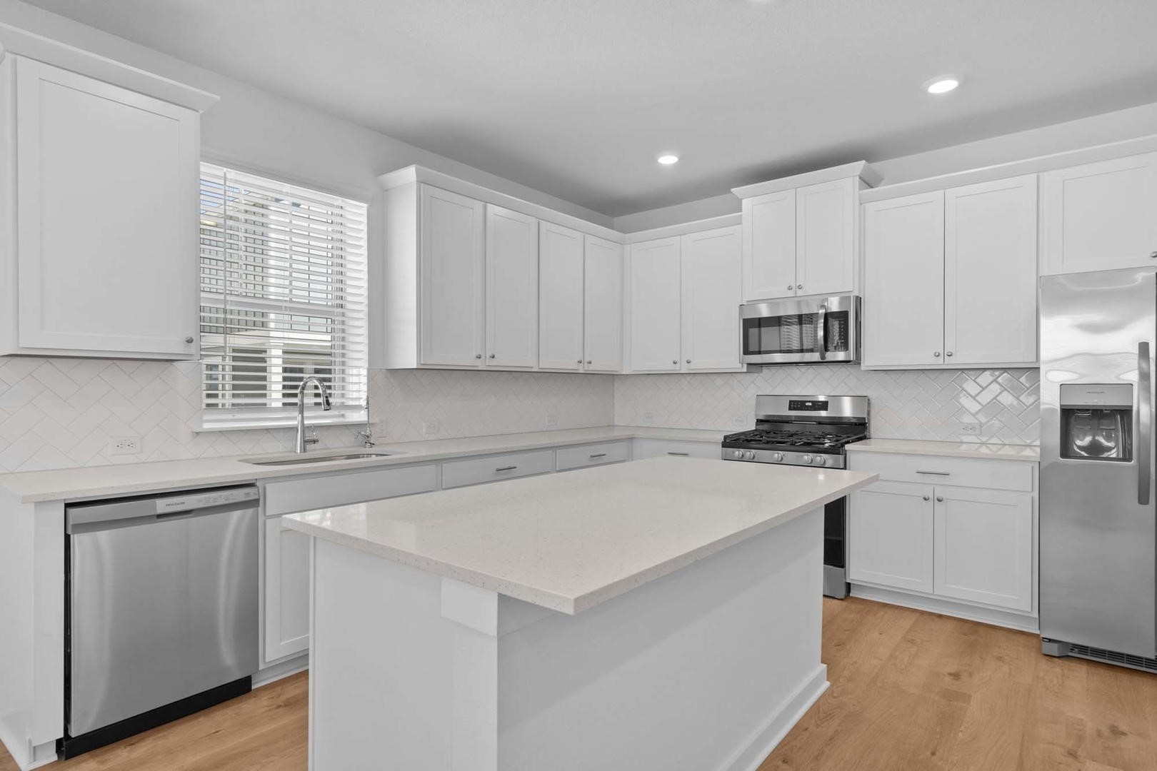 6400 Stockman Drive, Unit 6 Austin, TX 78747 - Photo 5 of 36 a kitchen with stainless steel appliances a sink a stove a refrigerator cabinets and a window