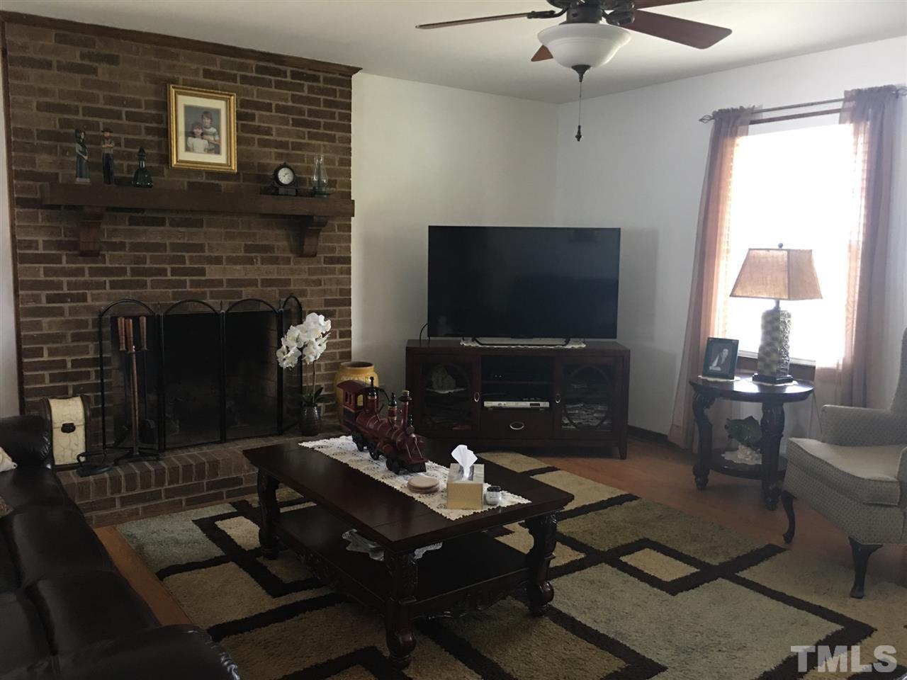 732 Clayhole Road Dunn, NC 28334 - Photo 5 of 18 With masonry fireplace and laminate flooring