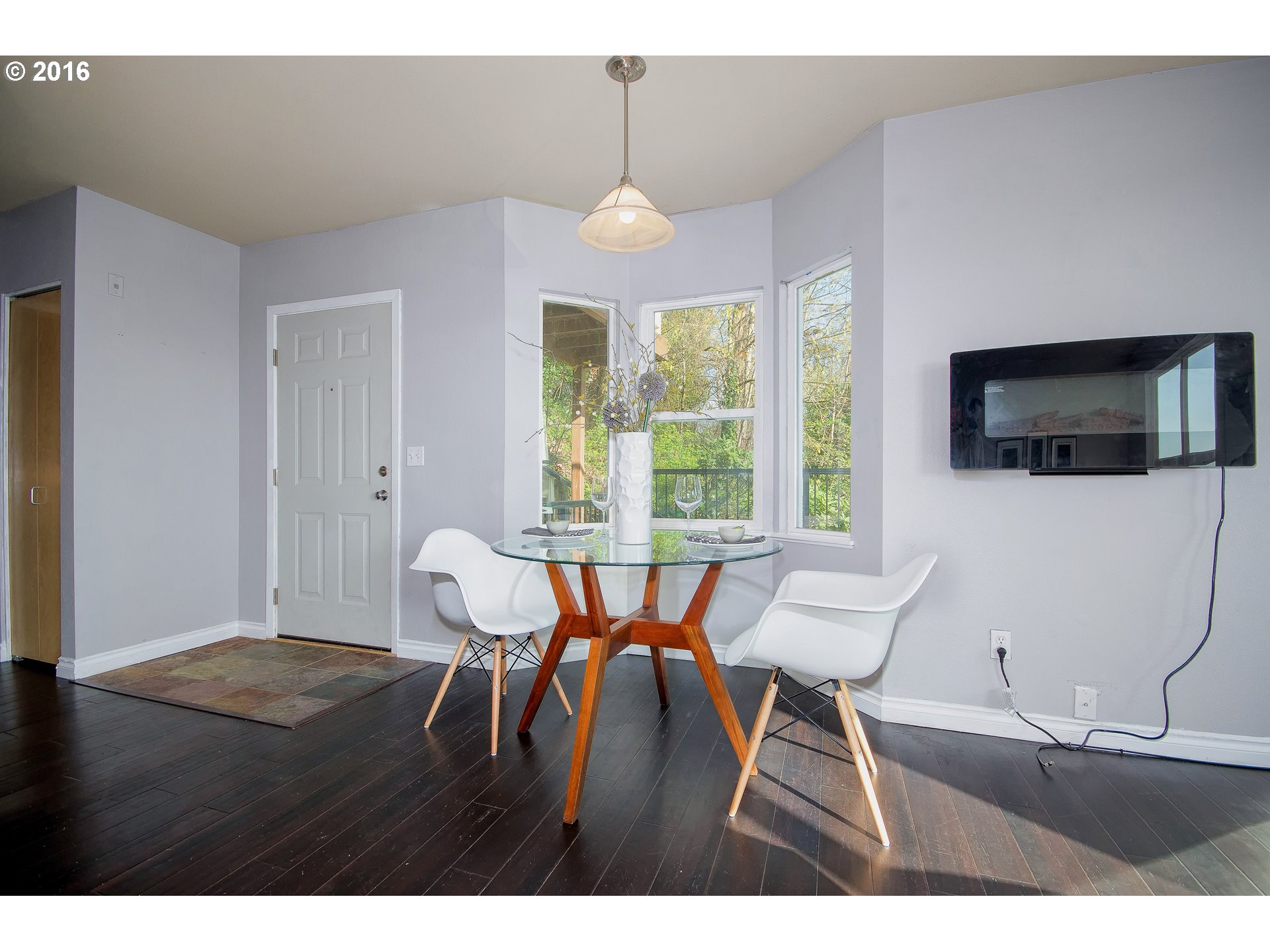 423 Northwest Uptown Terrace, Unit 1B Portland, OR 97210 - Photo 11 of 23 a view of a dining room with furniture window and wooden floor