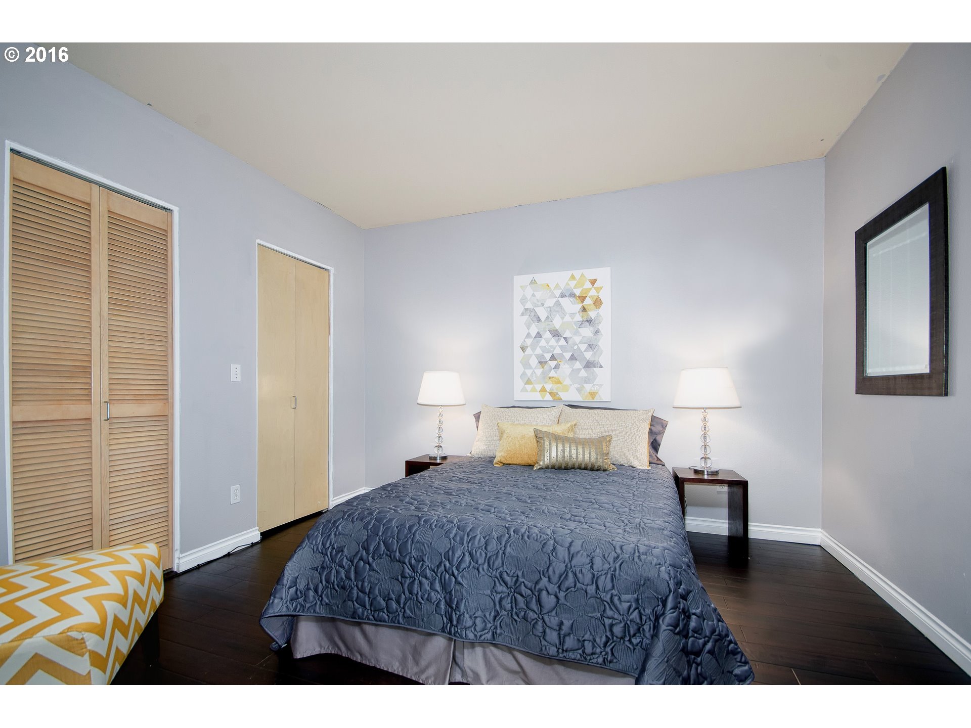 423 Northwest Uptown Terrace, Unit 1B Portland, OR 97210 - Photo 17 of 23 a bedroom with a bed and a lamp with window