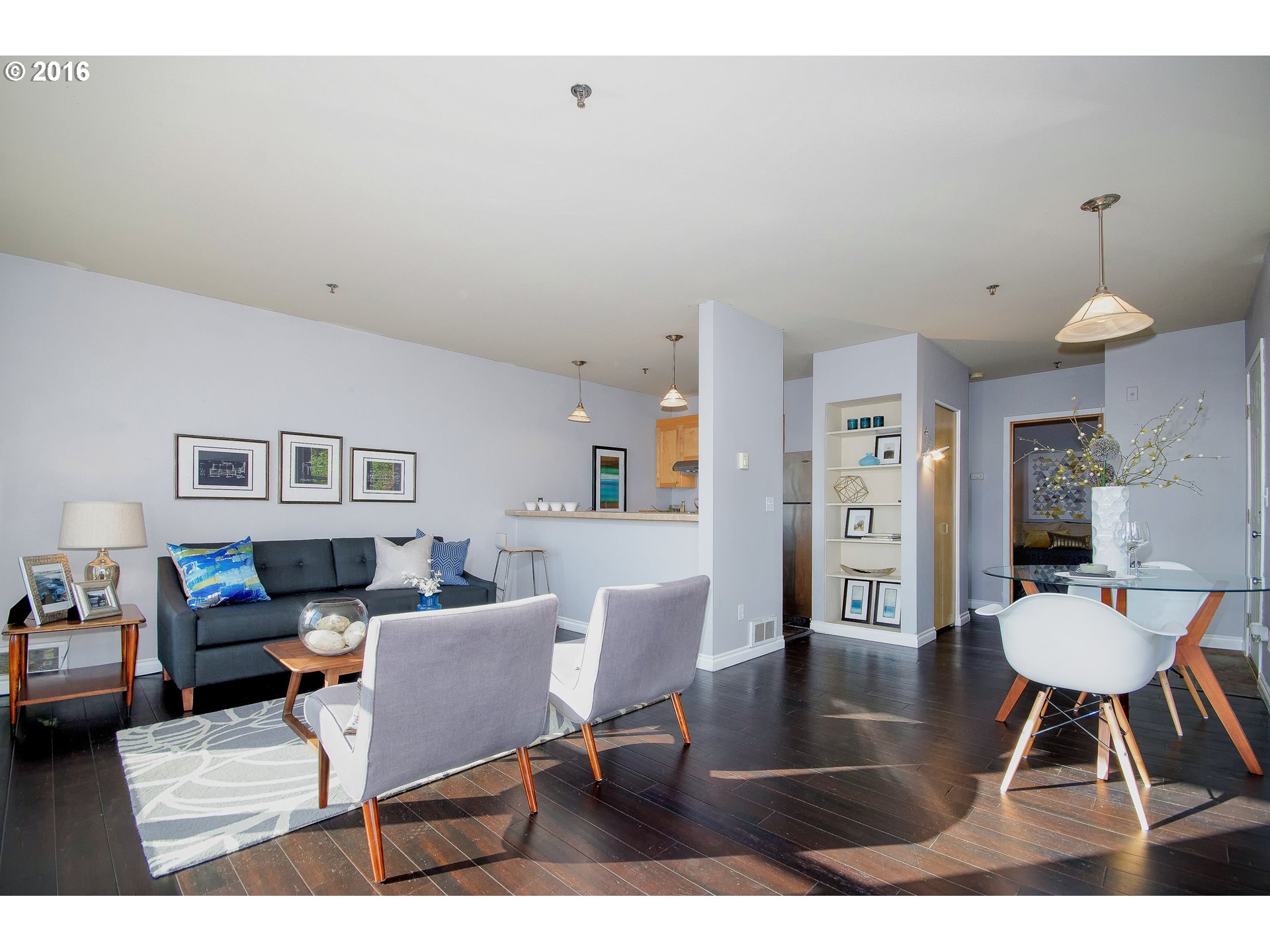 423 Northwest Uptown Terrace, Unit 1B Portland, OR 97210 - Photo 7 of 23 a living room with furniture and a dining table