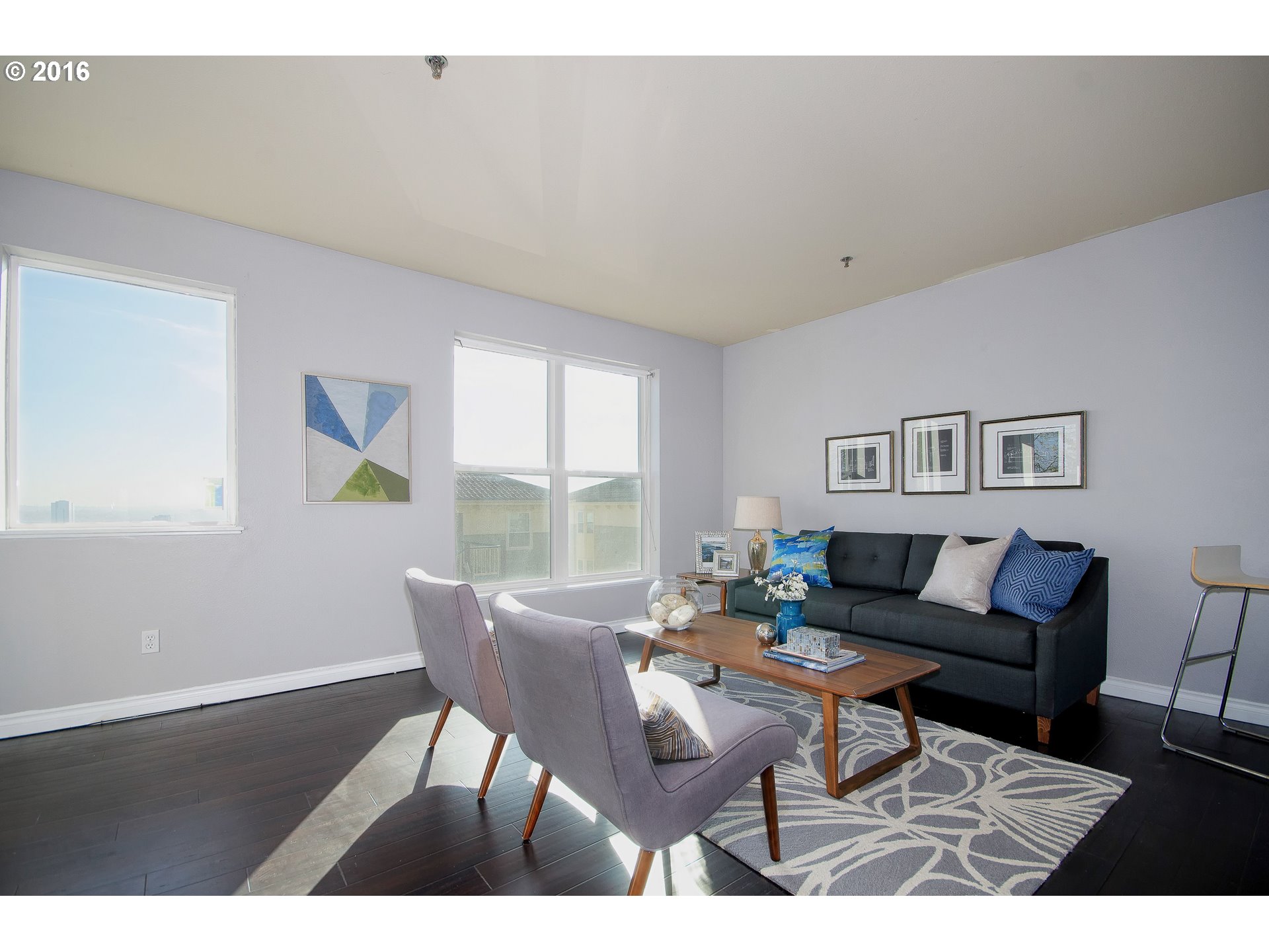 423 Northwest Uptown Terrace, Unit 1B Portland, OR 97210 - Photo 8 of 23 a living room with furniture and a wooden floor