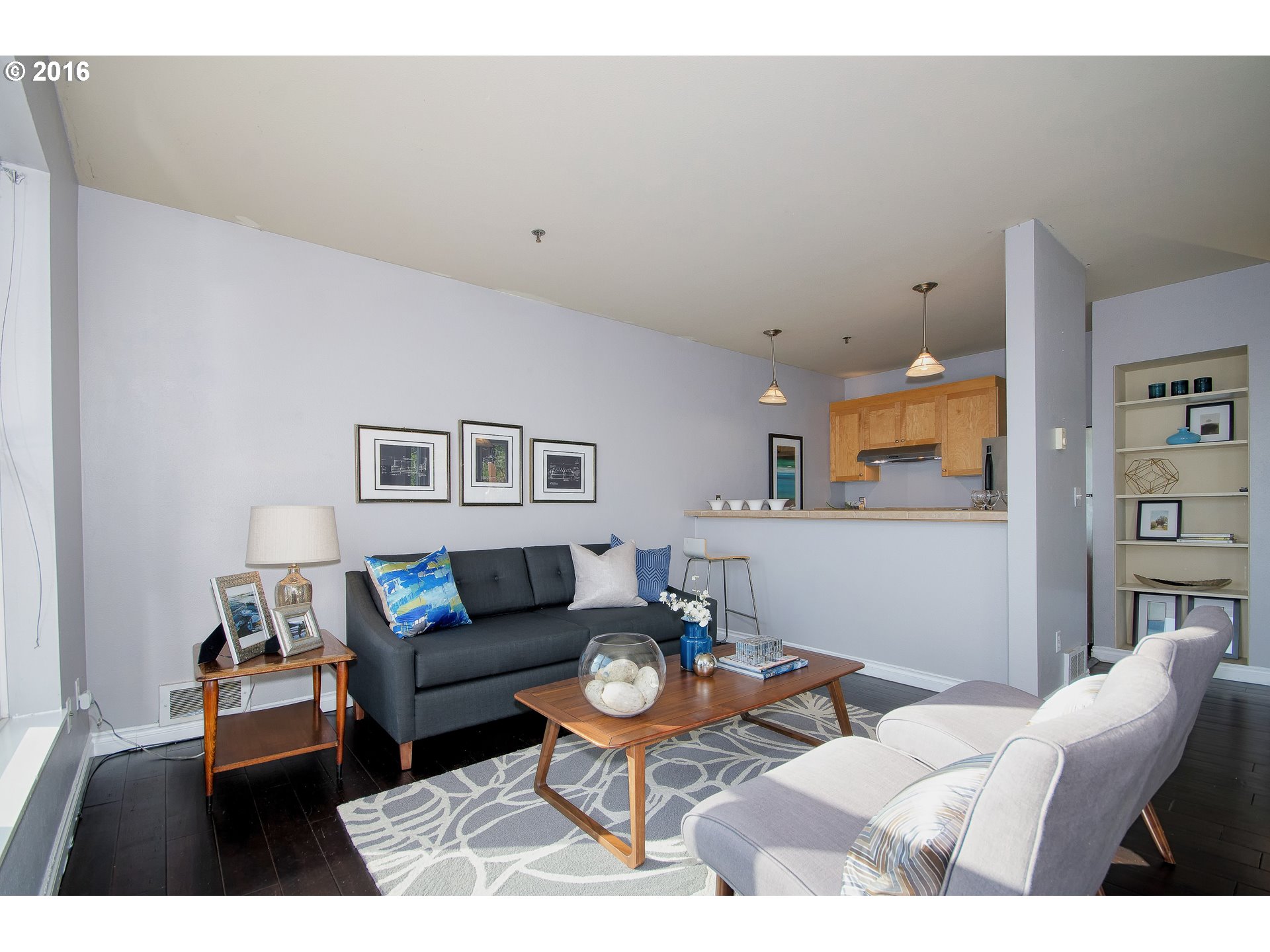 423 Northwest Uptown Terrace, Unit 1B Portland, OR 97210 - Photo 9 of 23 a living room with furniture and a rug