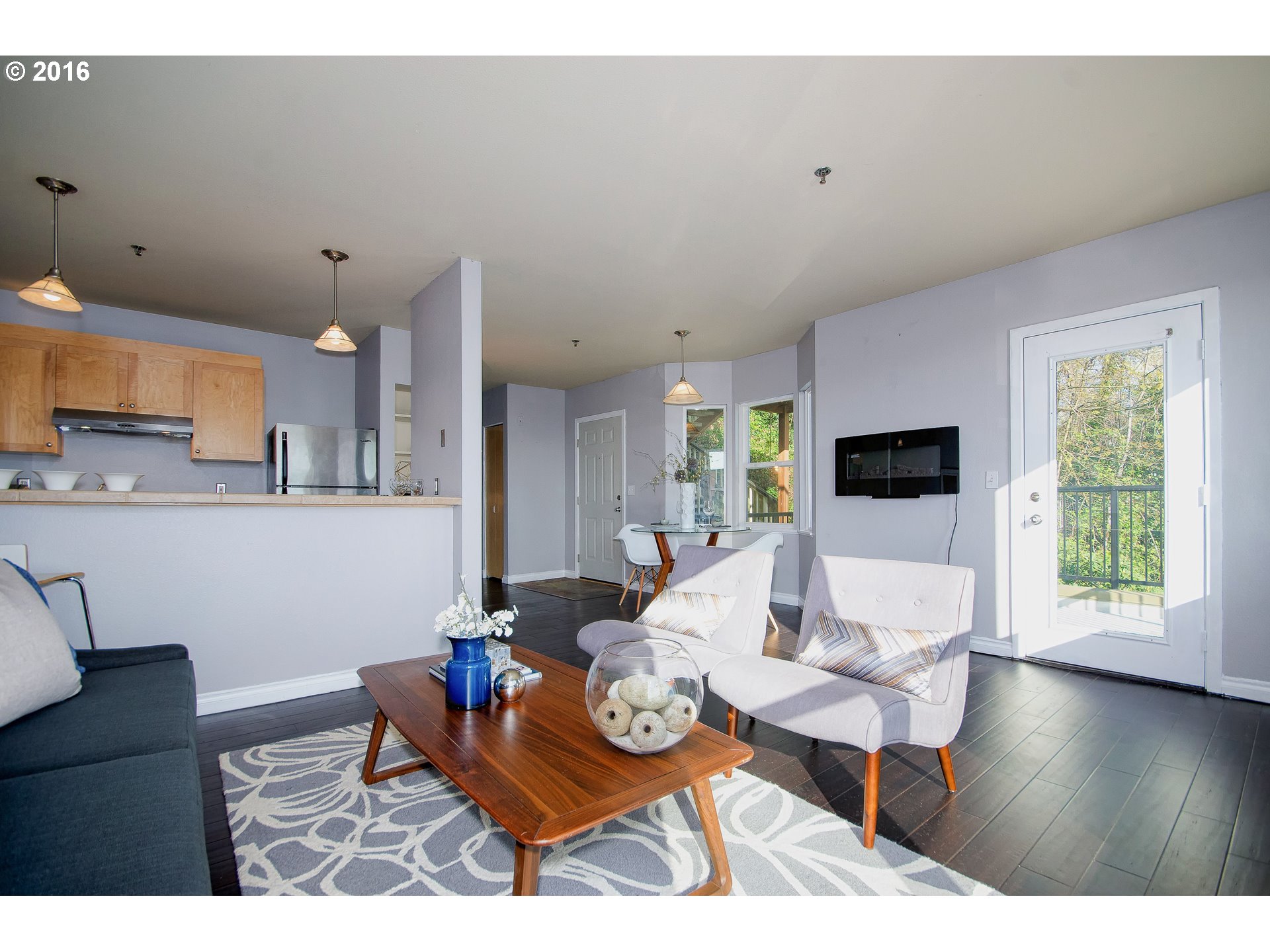 423 Northwest Uptown Terrace, Unit 1B Portland, OR 97210 - Photo 10 of 23 a living room with furniture and a flat screen tv