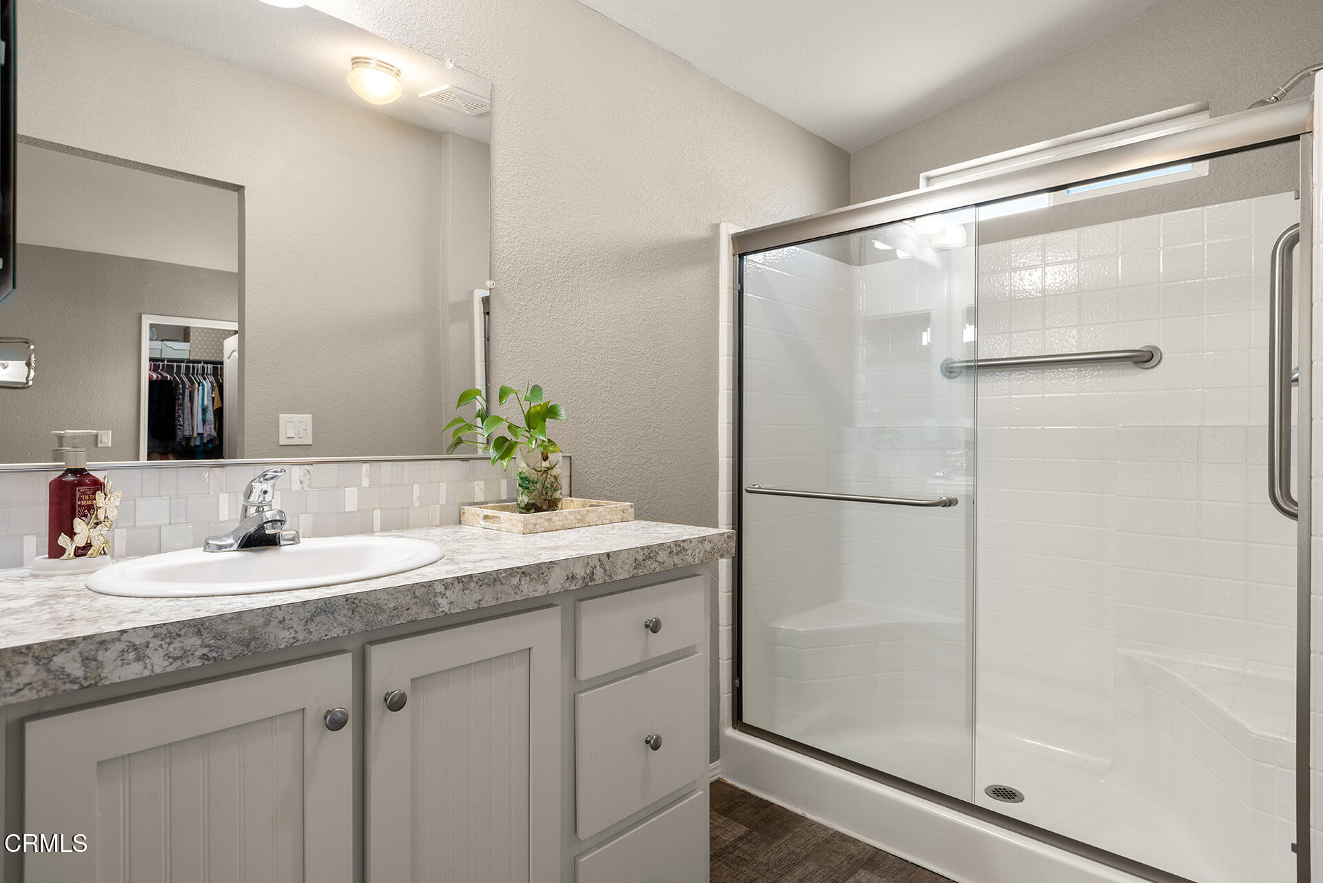 1500 Richmond Road, Unit 64 Santa Paula, CA 93060 - Photo 7 of 11 a bathroom with a granite countertop shower sink and mirror