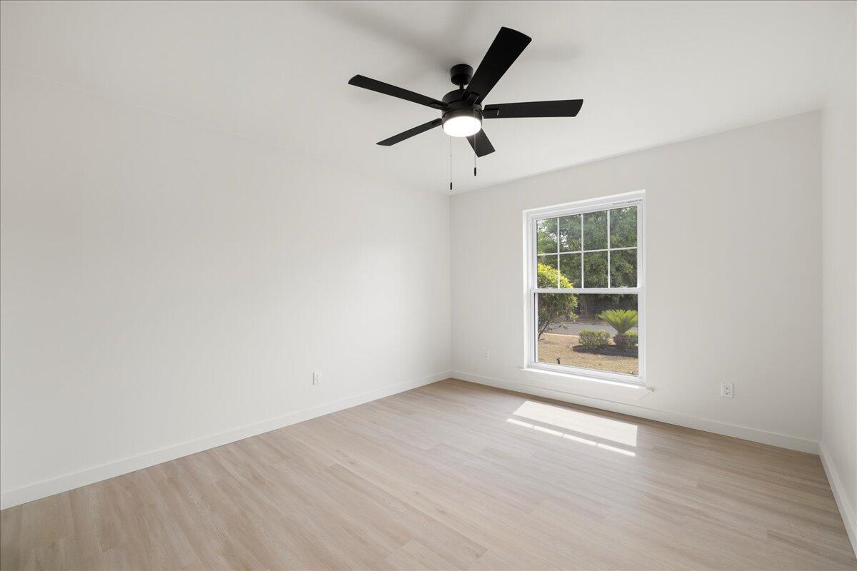 403 Cheyenne Circle Fort Walton Beach, FL 32547 - Photo 11 of 39 an empty room with wooden floor and windows
