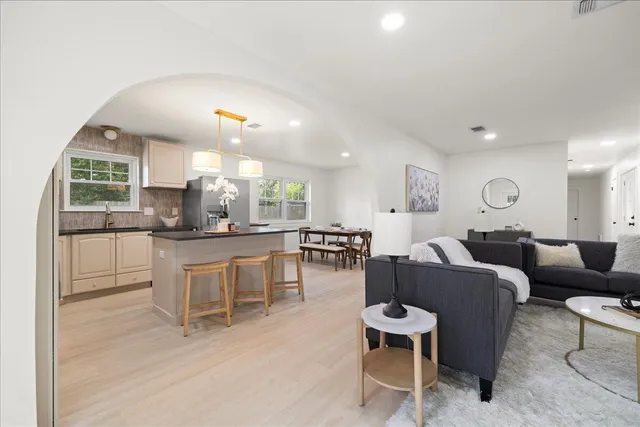a large kitchen with a table and chairs