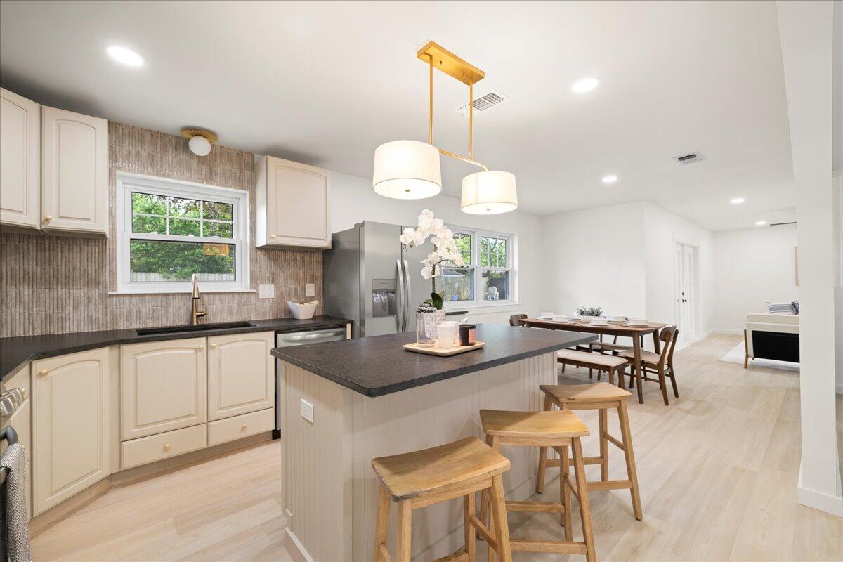 403 Cheyenne Circle Fort Walton Beach, FL 32547 - Photo 13 of 39 a kitchen with granite countertop a table chairs stove and cabinets