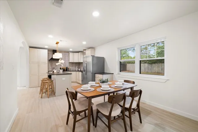 a dining room with furniture and window