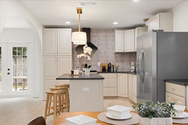 a kitchen with stainless steel appliances granite countertop a sink and refrigerator