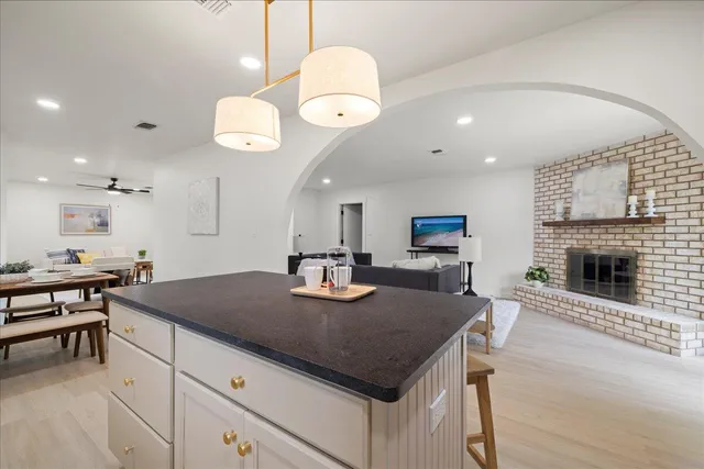 a kitchen with a counter space a sink and cabinets