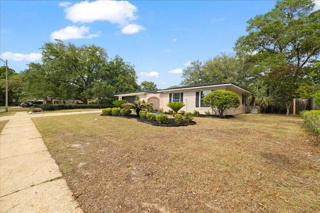 a view of house with outdoor space porch and garden
