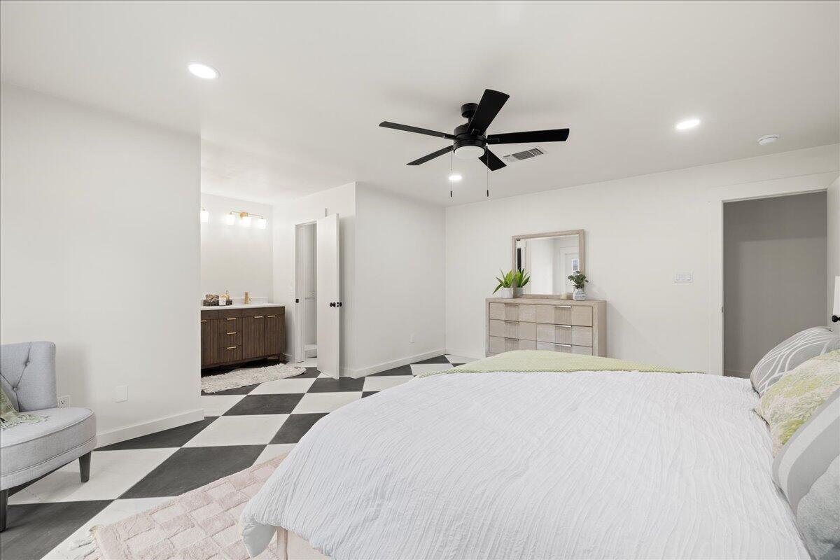 403 Cheyenne Circle Fort Walton Beach, FL 32547 - Photo 29 of 39 a bedroom with a large bed and a chandelier