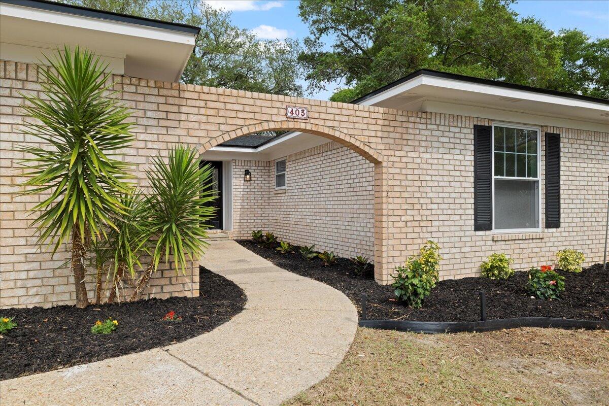 403 Cheyenne Circle Fort Walton Beach, FL 32547 - Photo 3 of 39 a front view of a house with a garden