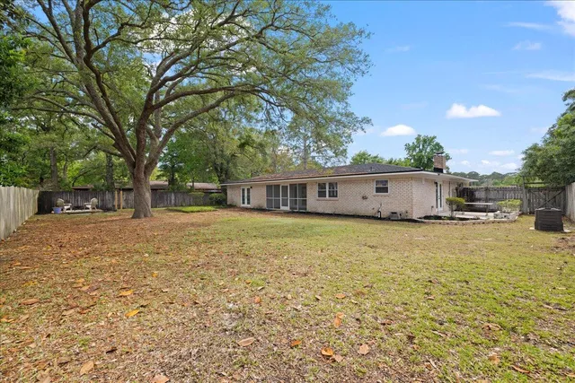 a view of a backyard with wooden fence