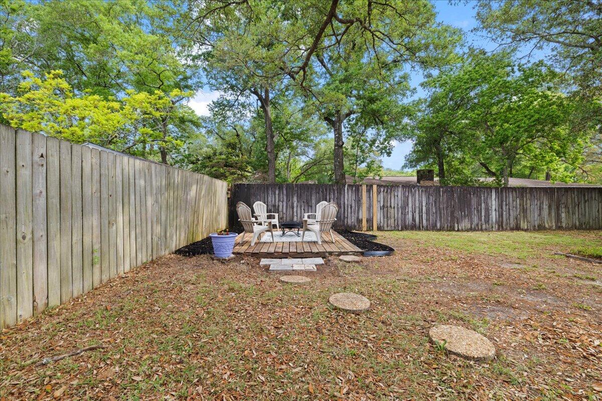403 Cheyenne Circle Fort Walton Beach, FL 32547 - Photo 37 of 39 a view of a backyard with table and chairs and wooden fence
