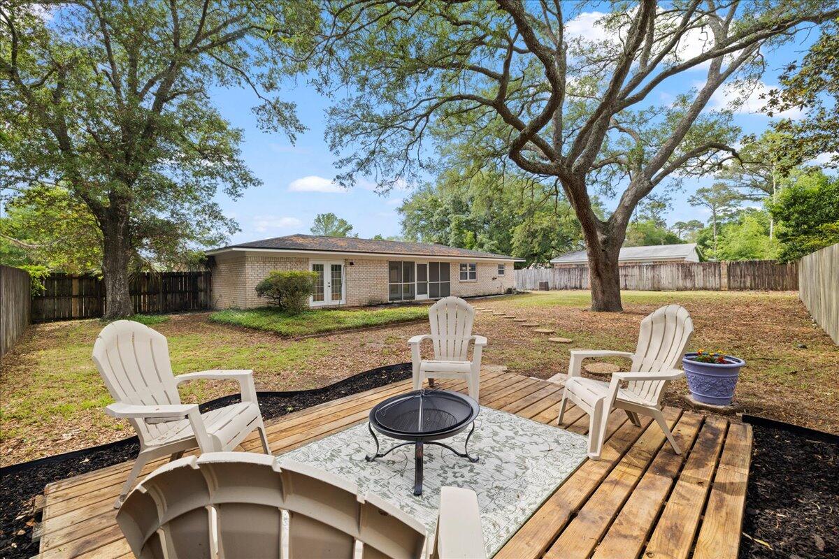 403 Cheyenne Circle Fort Walton Beach, FL 32547 - Photo 38 of 39 a view of a patio with table and chairs next to a large tree