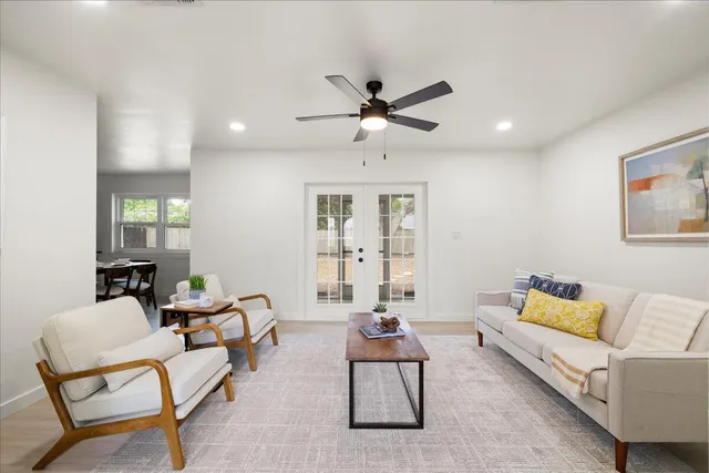 a living room with furniture and a chandelier