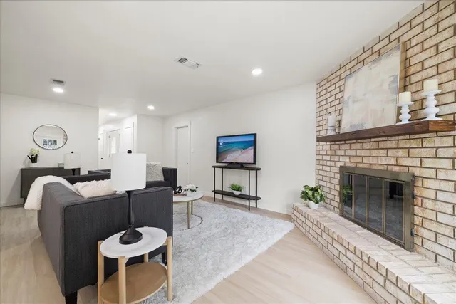 a living room with furniture a fireplace with wooden floor
