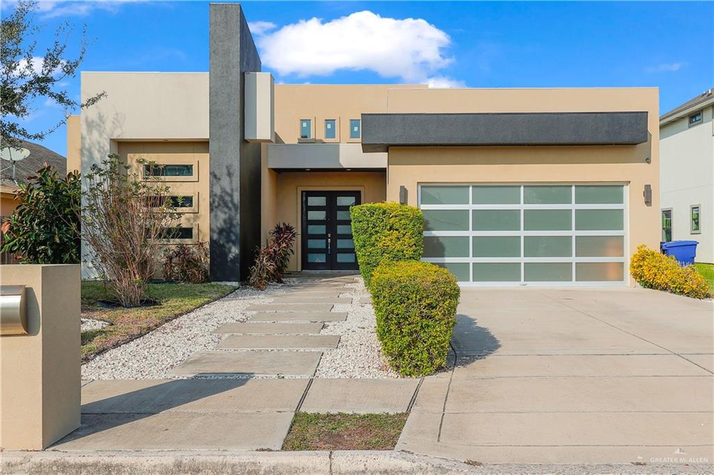 a front view of a house with a large window and a potted plant