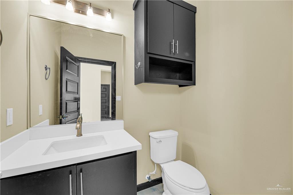 1720 Rice Avenue McAllen, TX 78504 - Photo 14 of 19 a bathroom with a sink a toilet and mirror