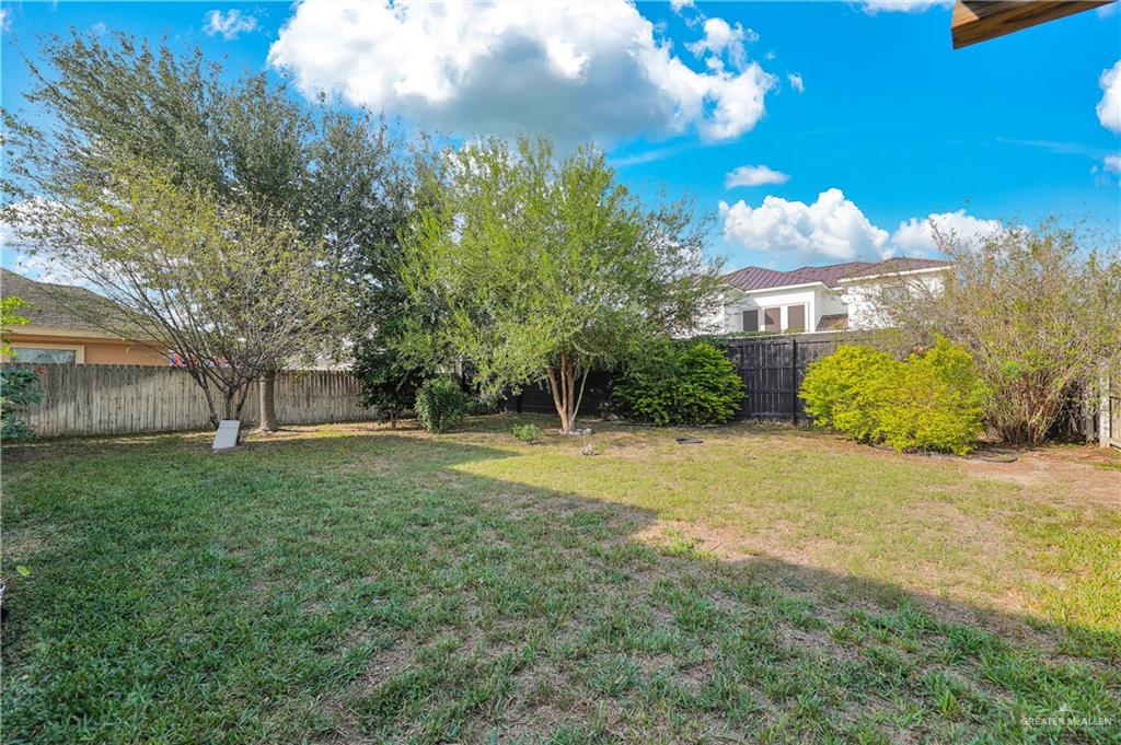 1720 Rice Avenue McAllen, TX 78504 - Photo 18 of 19 a view of a house with a big yard and large trees