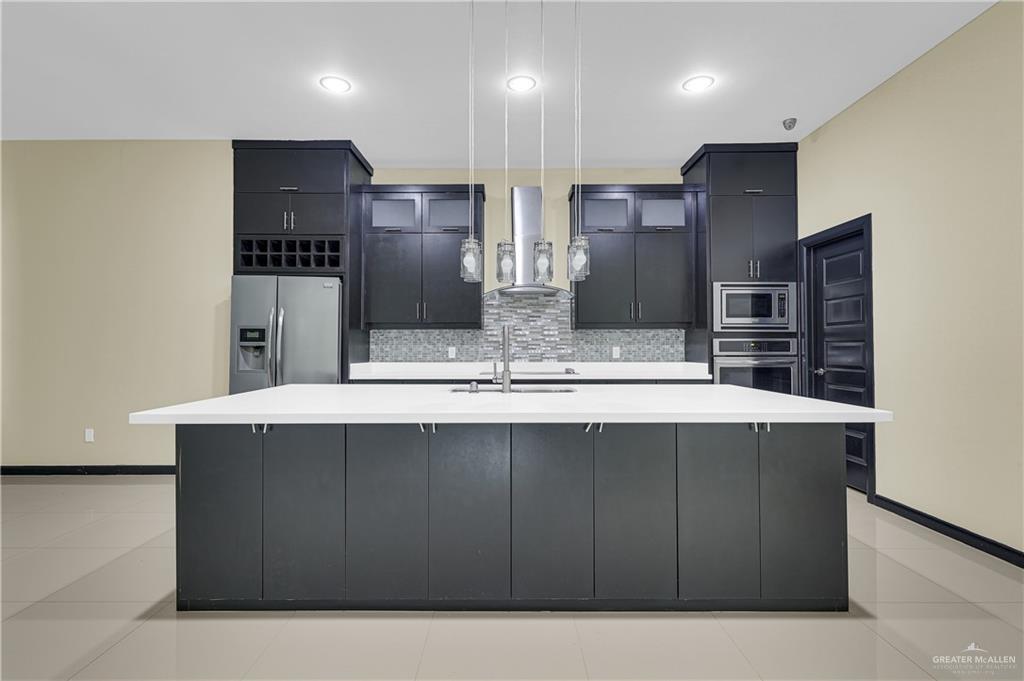1720 Rice Avenue McAllen, TX 78504 - Photo 7 of 19 a kitchen with stainless steel appliances a sink and a refrigerator