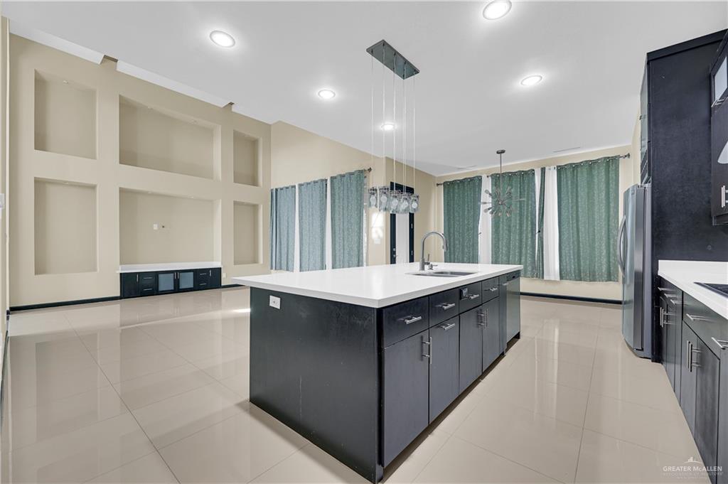 1720 Rice Avenue McAllen, TX 78504 - Photo 9 of 19 a kitchen with stainless steel appliances granite countertop a sink and a refrigerator