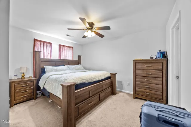 a bedroom with a bed and a dresser