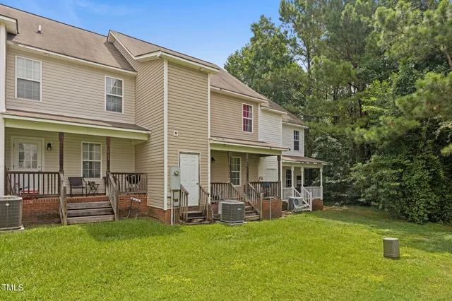 a view of a house with backyard porch and sitting area