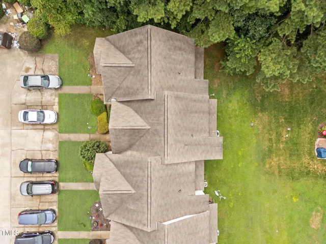 an aerial view of a residential houses with outdoor space