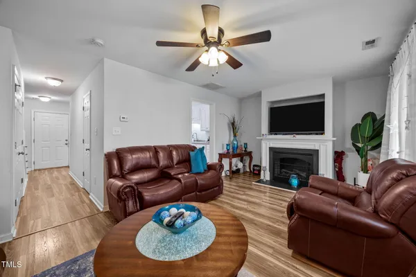 a living room with furniture a fireplace and a flat screen tv