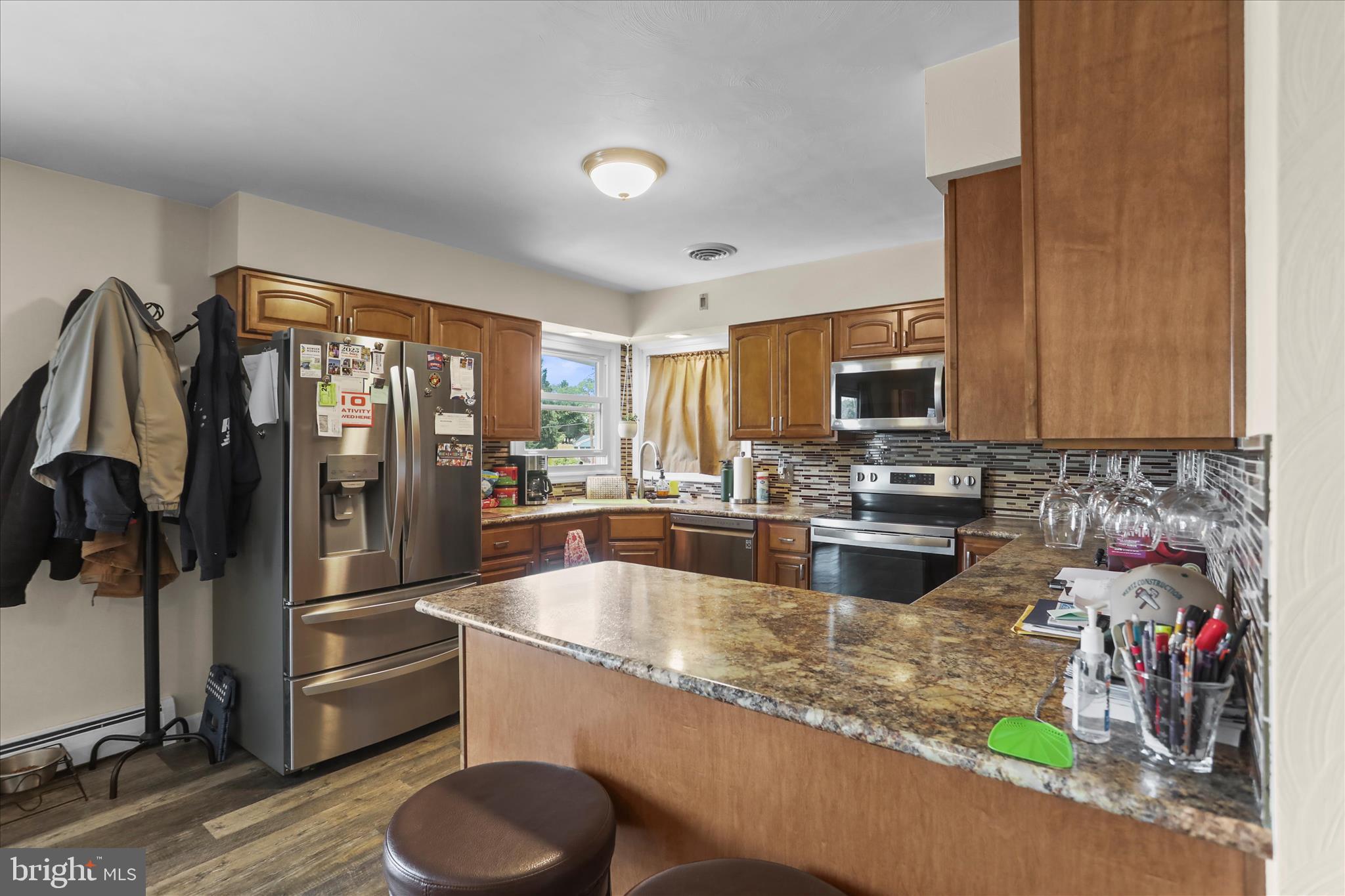 88 Sunset Drive Hanover, PA 17331 - Photo 11 of 51 a kitchen with stainless steel appliances granite countertop a refrigerator a stove and a sink with wooden floor