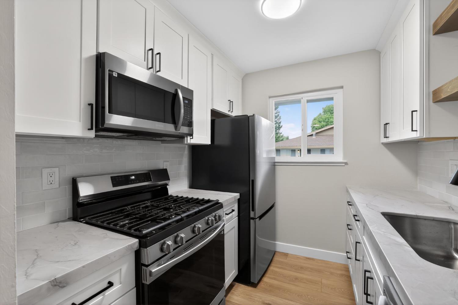 6281 Cavan Drive, Unit 4 Citrus Heights, CA 95621 - Photo 4 of 12 a kitchen with stainless steel appliances a stove a microwave and a sink