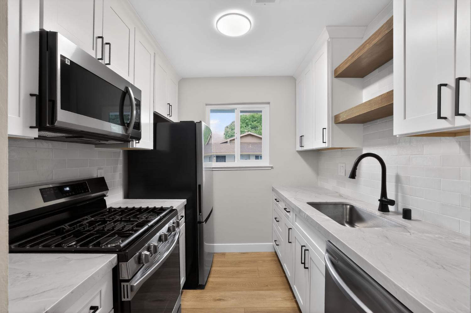 6281 Cavan Drive, Unit 4 Citrus Heights, CA 95621 - Photo 5 of 12 a kitchen with stainless steel appliances a sink dishwasher a stove and a microwave oven with cabinets
