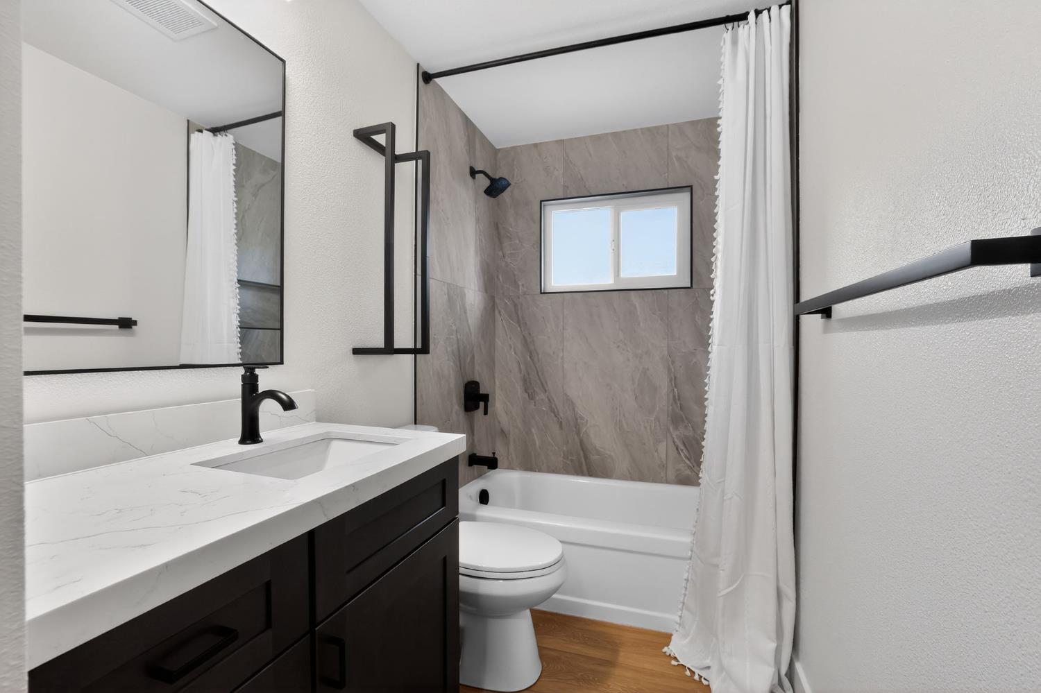6281 Cavan Drive, Unit 4 Citrus Heights, CA 95621 - Photo 7 of 12 a bathroom with a sink a toilet and shower