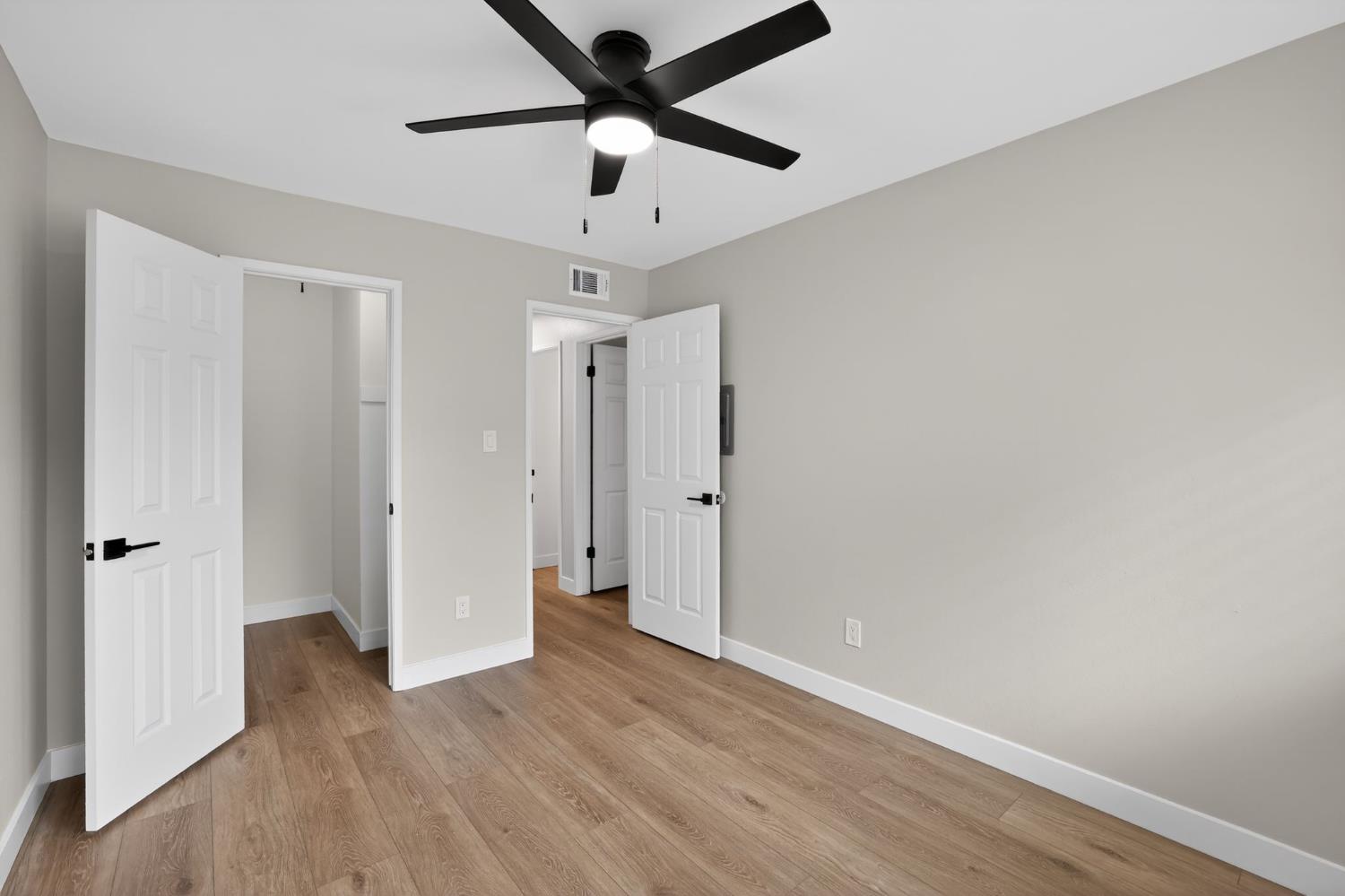 6281 Cavan Drive, Unit 4 Citrus Heights, CA 95621 - Photo 8 of 12 an empty room with wooden floor and a ceiling fan