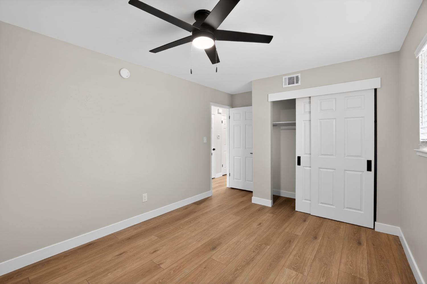 6281 Cavan Drive, Unit 4 Citrus Heights, CA 95621 - Photo 10 of 12 an empty room with wooden floor and a ceiling fan
