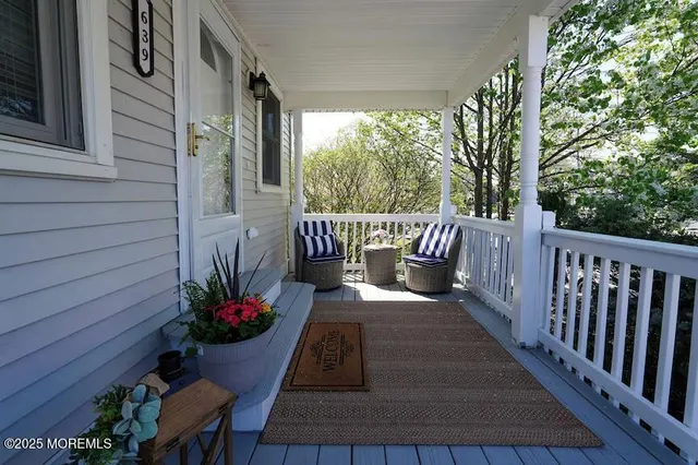 a view of balcony with furniture and garden