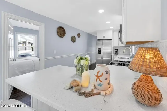 a living room with kitchen island furniture and decor