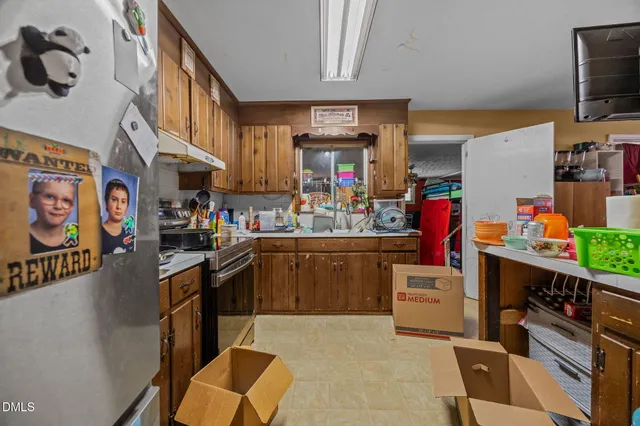 a view of a dining room with furniture one side kitchen view
