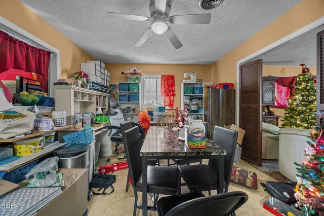 a kitchen with stainless steel appliances kitchen island granite countertop a refrigerator and a stove top oven