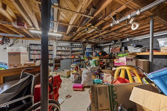 a view of a storage room with racks shoes and chairs