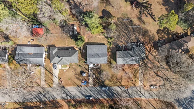 a front view of a house with a tree