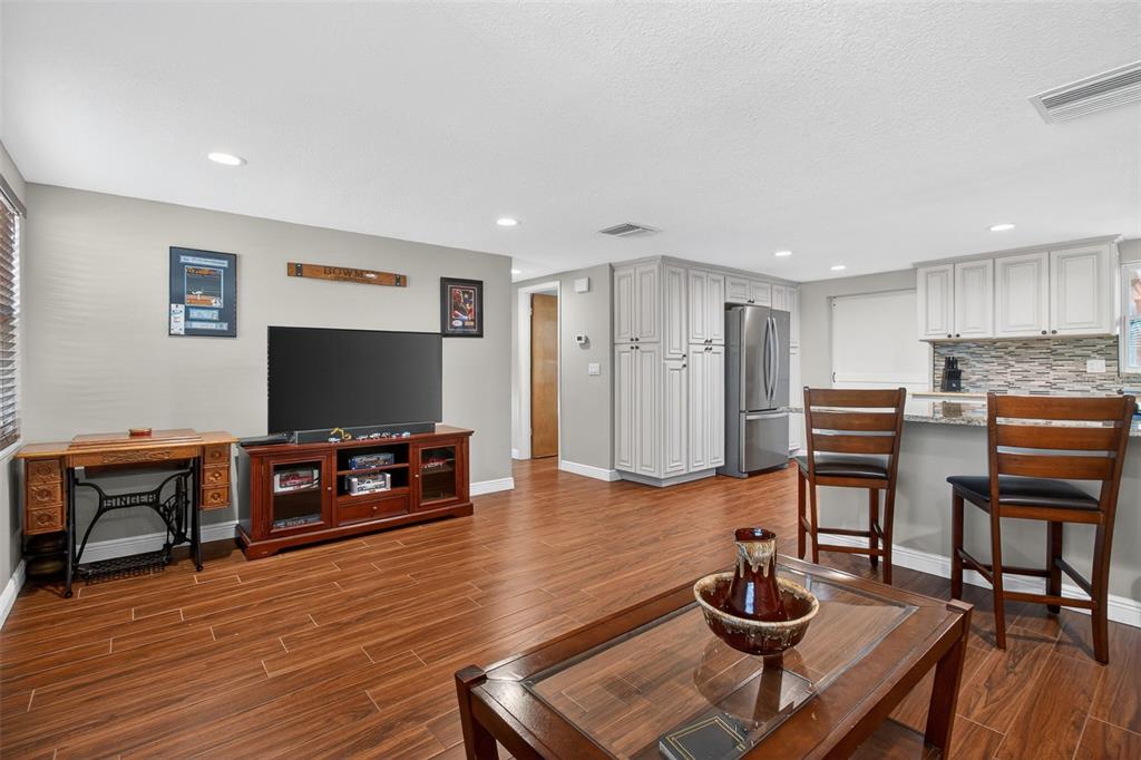 5134 Reseda Drive New Port Richey, FL 34652 - Photo 12 of 37 a living room with furniture and a flat screen tv